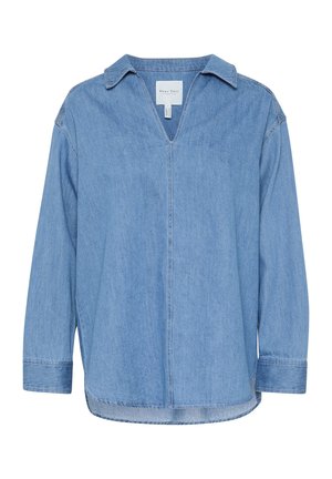 Haut en denim bleu clair avec un col en V, des manches longues et une coupe décontractée. Présente des coutures discrètes et un ourlet arrondi. Fabriqué en matière cotton.