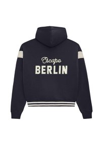 Navy hoodie with white stripes on sleeves and hem, featuring "Escape BERLIN" text embroidered on the back.
