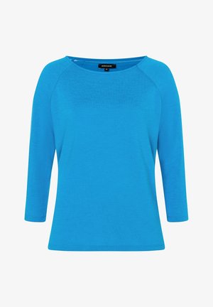 Blauwe top met lange mouwen gemaakt van zacht materiaal. Heeft een brede boot-halslijn en een rechte pasvorm, met raglanmouwen en een gladde textuur.