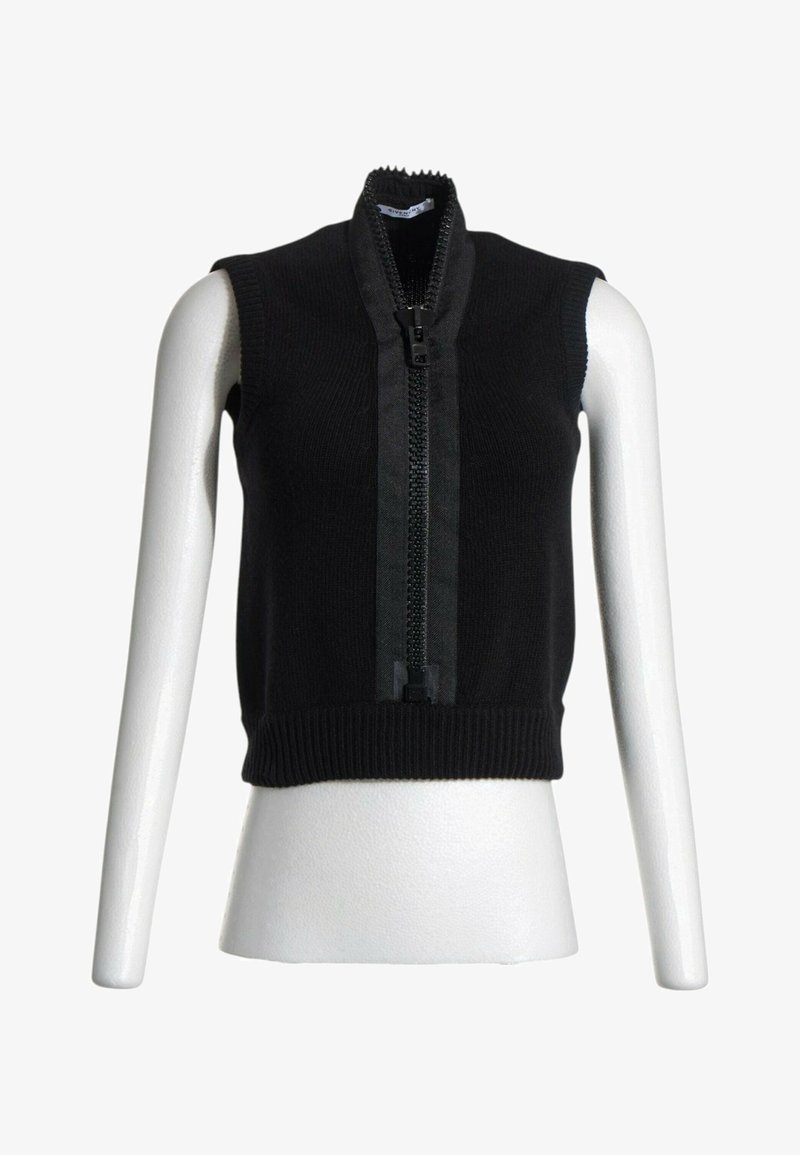 Veste noire sans manches en maille avec une grande fermeture éclair noire centrale et un col haut, présentée sur un buste de mannequin blanc.
