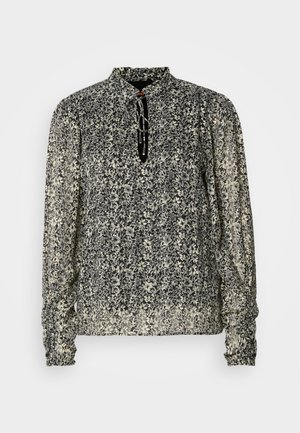 Blusa a maniche lunghe in stampa floreale nera e crema, con colletto alto e polsini arricciati. Tessuto leggero e trasparente con una vestibilità comoda.
