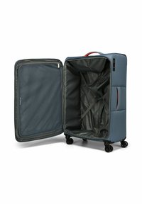 Valigia rigida blu con manico beige. Interno con rivestimento grigio, cinghie regolabili e un compartimento con cerniera. Quattro ruote per la mobilità.