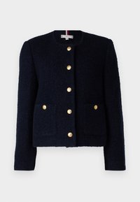 Námořnická strukturovaná bunda s kulatým výstřihem, zlatými knoflíky, dvěma předními kapsami a slim fit designem. Obsahuje pruhovanou vnitřní štítek.