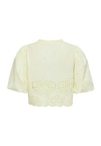 Blouse couleur crème avec manches courtes bouffantes, col à volants et détails de dentelle ajourée complexe le long de l'ourlet et du dos.
