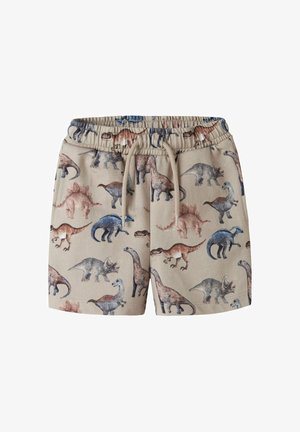 Short beige à taille élastique avec cordon, décoré d'illustrations multicolores de dinosaures dont Stegosaurus, Triceratops et Brachiosaurus.