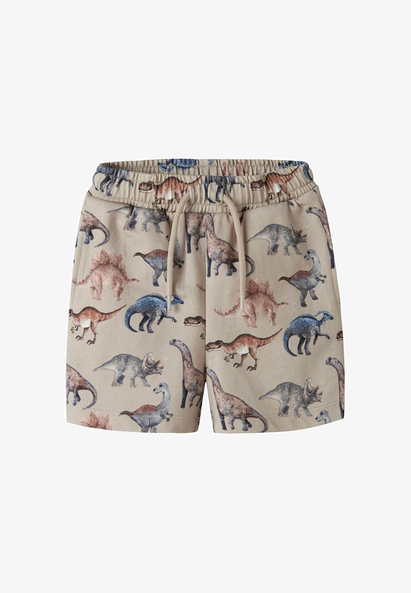 Short beige à taille élastique avec cordon, décoré d'illustrations multicolores de dinosaures dont Stegosaurus, Triceratops et Brachiosaurus.