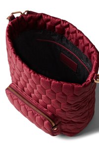 Textured burgundy handbag with a honeycomb pattern, featuring a soft interior, a zippered front pocket, and a gold metal zipper.
