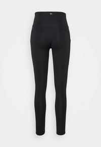Black high-waisted leggings with a back zippered pocket, shown from the rear on a white background.