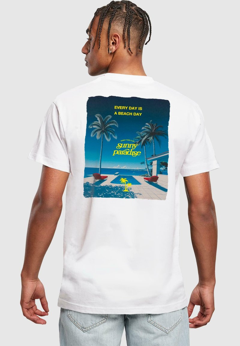 White cotton t-shirt featuring a colorful graphic print on the back, depicting palm trees and poolside scenery with text "Every Day is a Beach Day."