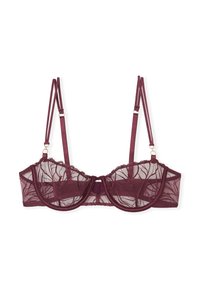 Soutien-gorge en dentelle mauve avec un design transparent, un soutien à armatures, des bords en festons et des bretelles réglables ornées d'accents en métal doré.