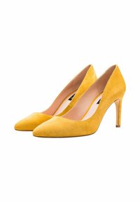 Zapatos de tacón alto de ante amarillo con punta afilada, que ofrecen una textura suave y un delgado tacón de aguja para un diseño elegante.