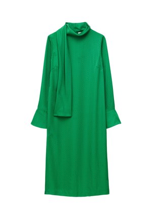 Green dress with a mock turtleneck, long sleeves, and flared cuffs. Features a textured fabric with a dotted pattern and a matching scarf.
