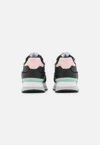 Black and pink sneaker with a textured upper, contrasting mint green midsole, and a white and grey outsole. Laces and padded collar included.