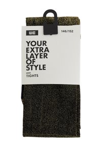 Fekete harisnyanadrág aranyszínű fém szálakkal, összehajtatva és csomagolva, címkével, amelyen az áll: "A te extra stílusréteged", méret: 146/152.