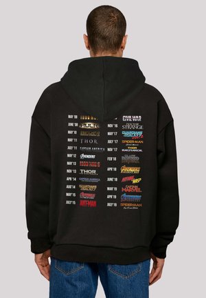 Black hoodie featuring movie titles and release dates in varied colors on the back, with a large pocket and a drawstring hood.