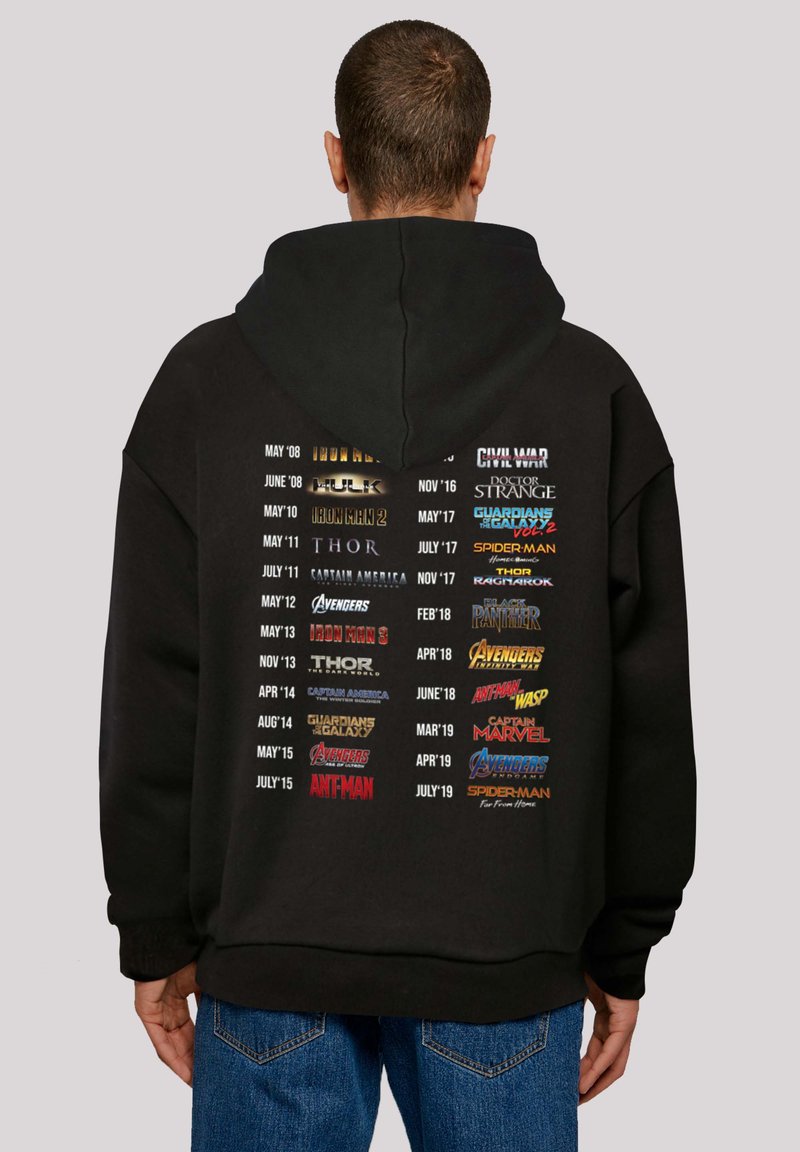 Black hoodie featuring movie titles and release dates in varied colors on the back, with a large pocket and a drawstring hood.