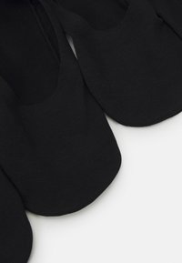 Schwarze Ballerinas aus weichem Stoff, mit runder Zehenpartie und minimalistischem Design, das glatte Kanten und keine sichtbaren Beschläge aufweist.