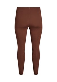 Zwarte leggings gemaakt van een gladde, rekbare stof. Ze hebben een aansluitend ontwerp zonder zichtbare naden of hardware, met een middelhoge tailleband.