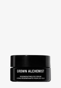 Pot noir avec une finition brillante et une étiquette blanche. Le texte indique "GROWN ALCHEMIST" et "CRÈME POUR LES YEUX RÉGÉNÉRANTE" dans une police claire.