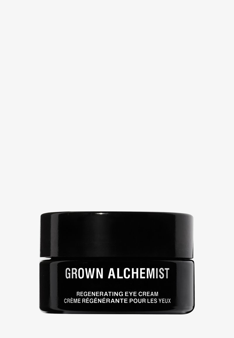 Pot noir avec une finition brillante et une étiquette blanche. Le texte indique "GROWN ALCHEMIST" et "CRÈME POUR LES YEUX RÉGÉNÉRANTE" dans une police claire.