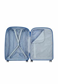 Interno della valigia rigida blu con fodera grigia, cinghie incrociate elastiche e una tasca in rete. Chiusura con zip e ruote robuste per la mobilità.