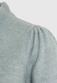 Light blue knit sweater featuring a high neckline, ribbed texture, and puffed sleeves with gathered detailing. Soft, cozy material.