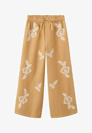 Weit geschnittene beige Hose mit elastischem Bund und Kordelzug, verziert mit gleichmäßig verteilten weißen, bestickten Blumenmustern.