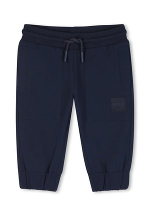 Pantalon jogger bleu foncé à taille élastique avec cordon, poches plaquées à l'avant, chevilles resserrées et une petite étiquette de marque sur la poche droite.