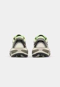 Trail running shoes with a light gray mesh upper, black and green accents, cushioned sole, and textured rubber outsole for traction.