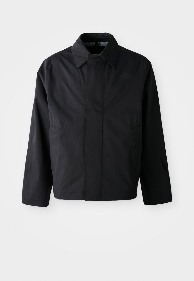 Schwarze, kurze Jacke mit umgeschlagenem Kragen, zwei Fronttaschen und langen Ärmeln. Hergestellt aus glattem, leichtem Material mit dezentem Branding.