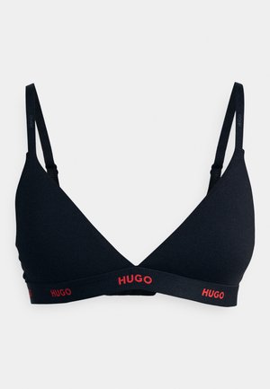 Black triangle bralette in smooth fabric with narrow straps and a wide band featuring red "HUGO" logo on the front. Adjustable strap design.