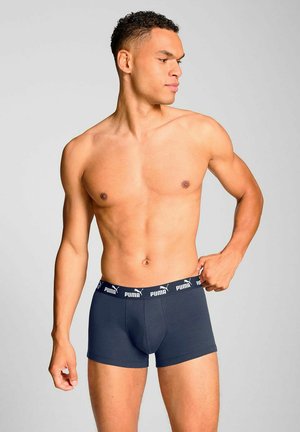Marineblaue Herren-Boxershorts aus weichem Material, mit einem elastischen Bund mit Logo und einer engen Passform, sowie einer glatten Textur.