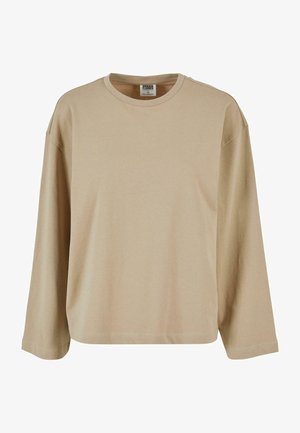 Beež pikkade varrukatega T-särk, mis on valmistatud pehmest puuvillast, ümmarguse kaelusega ja lõdva istuvusega. Sujuv tekstuur ja minimaalne õmbluse detail.