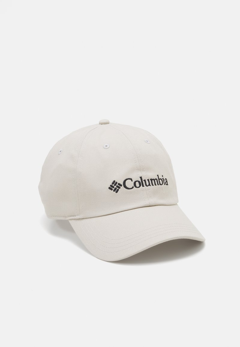 Beige baseballcaps laget av stoff med en buet skjerm. Har en brodert svart "Columbia" logo på fronten.