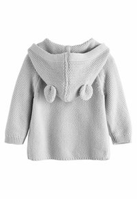 Felpa con cappuccio grigio chiaro realizzata a maglia con una finitura texturizzata, dotata di un ampio cappuccio e due dettagli a pom-pom sul retro. Maniche lunghe e bordo a coste.