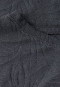 Dark gray fabric featuring a subtle leaf pattern with a smooth texture; includes a rounded neckline and visible stitching details.