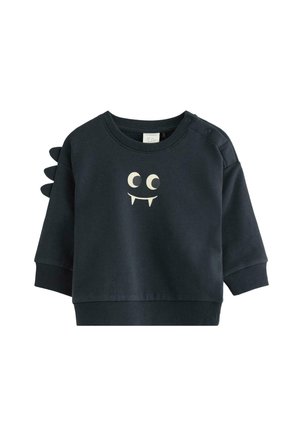 Sweatshirt pour enfant en bleu foncé avec un imprimé d'yeux de monstre et de dents, et trois pointes en tissu sur l'épaule gauche.