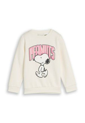 Witte trui met lange mouwen met een illustratie van Snoopy die loopt en het woord "PEANUTS" in grote roze letters erboven.