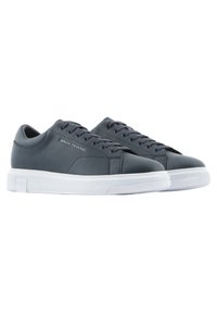 Gray leather sneakers with white rubber soles. Features include a textured finish, round toe, and contrasting laces. "Armani Exchange" logo on side.