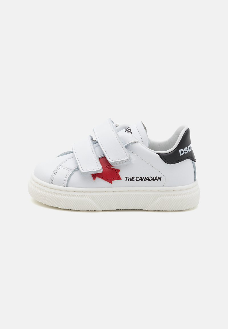 White leather sneakers with velcro straps, red star design, black heel accent, and printed text. Elevated rubber sole for stability.