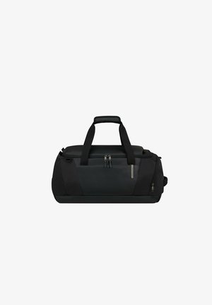 Black duffel bag made of durable fabric. Features dual handles, a zippered top, and side pocket with metal accents. Rectangular shape.