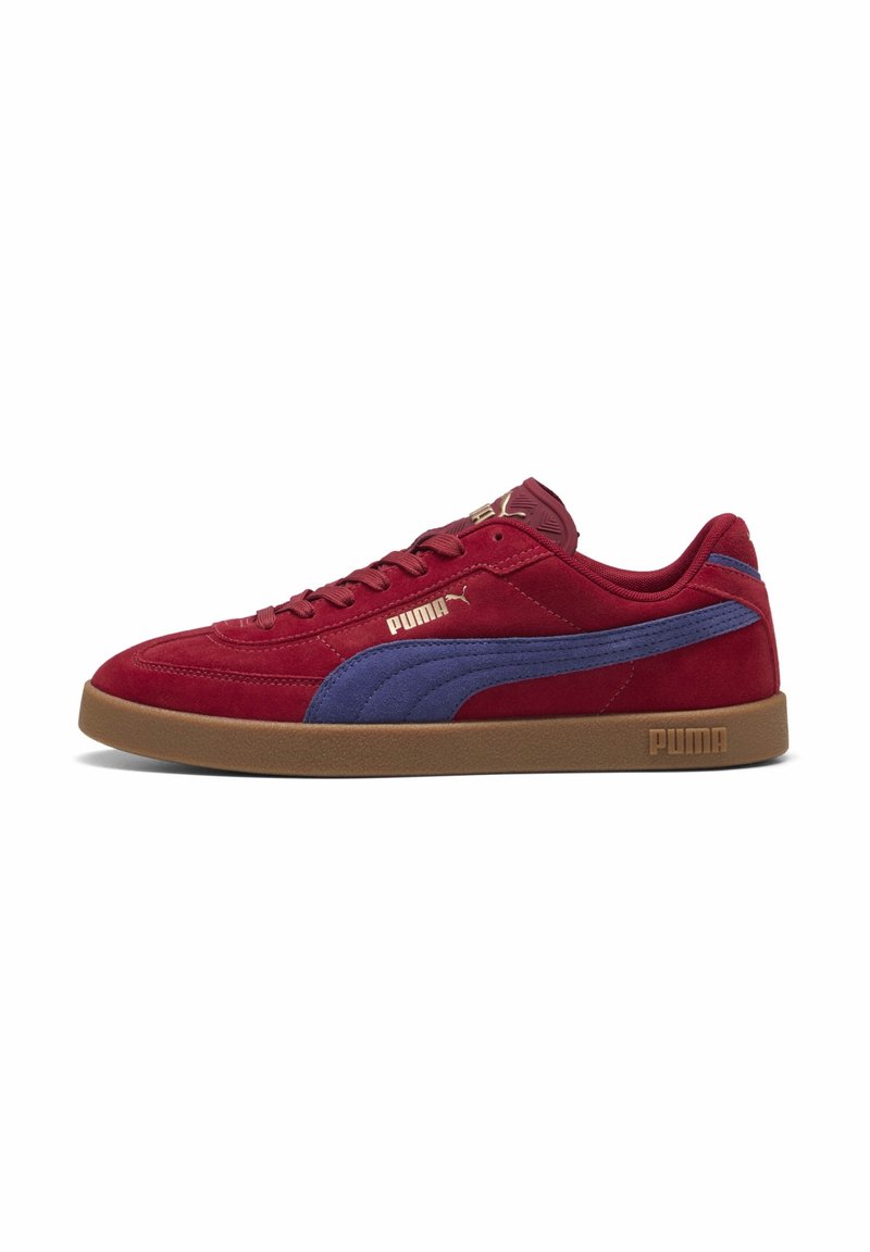 Baskets Puma en daim rouge avec une bande bleue, semelle marron et logo Puma doré sur le côté et la languette, vues de l'extérieur.