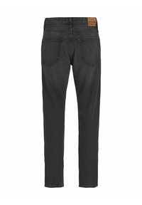 Svarta denimjeans med rak passform. Har två bakfickor och en läderlabel vid midjan. Enkel, minimalistisk design.
