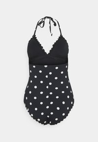 Schwarzer Badeanzug mit Polka-Dots, Halterneck, gewellten Kanten und einer taillierten Oberseite, der im unteren Bereich weiße Polka-Dots aufweist.