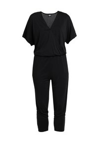 Combinaison noire à manches courtes avec col en V, taille élastique et pantalon fuselé longueur cheville.