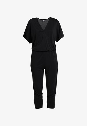 Combinaison noire à manches courtes avec col en V, taille élastique et pantalon fuselé longueur cheville.