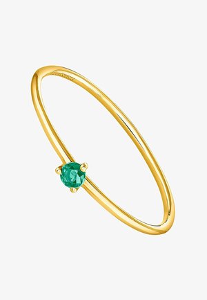 Brazalete de oro con acabado suave, que presenta una piedra verde redonda central, engastada en cuatro garras, destacando la elegancia simple y el contraste de color.