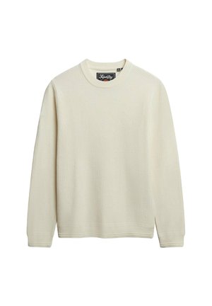 Cremefarvet sweater med et struktureret strikkemønster, rund halsudskæring og lange ærmer. Har sidespalter samt ribbede manchetter og kant.