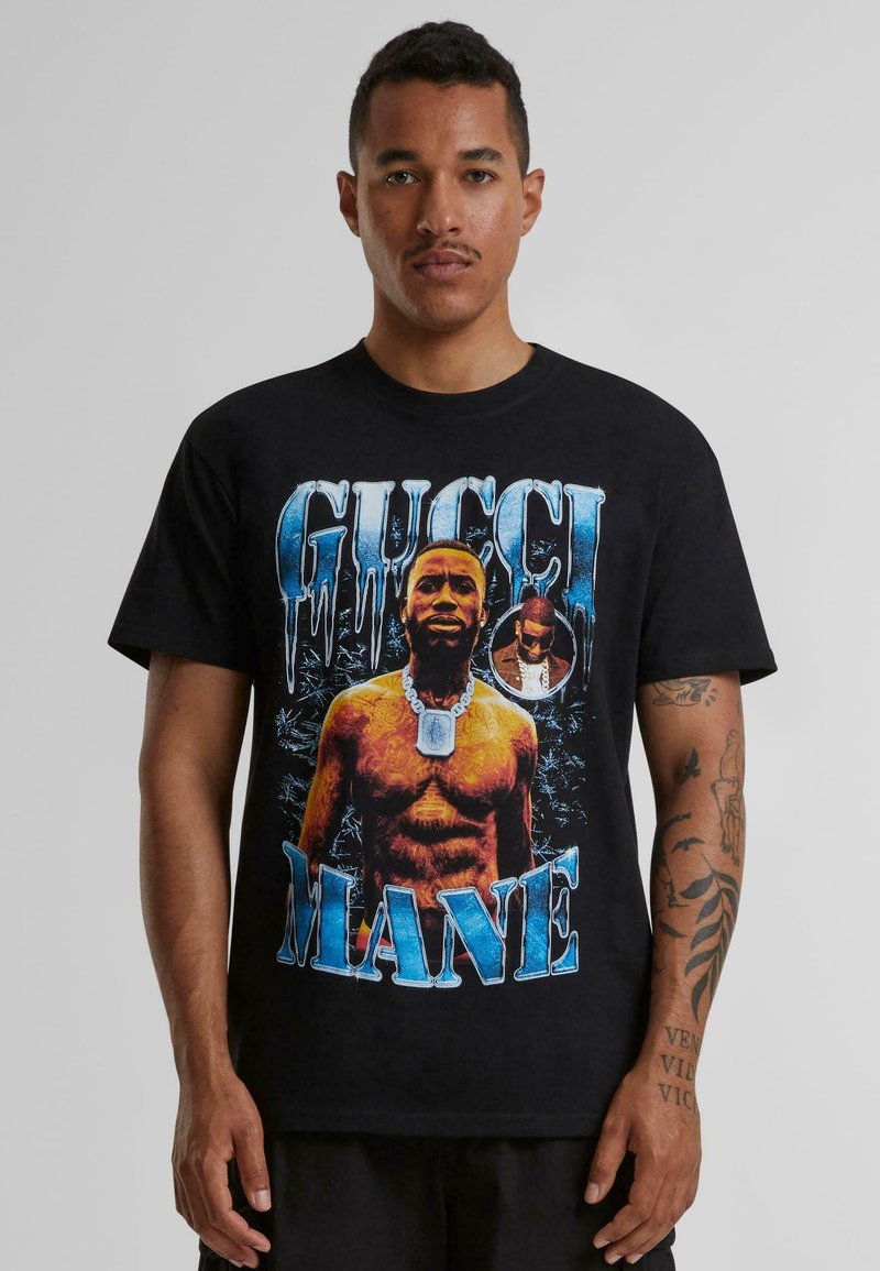 Black cotton t-shirt featuring a graphic print of a muscular figure with jewelry and the text "GUCCI MANE" in blue, with icy detailing.