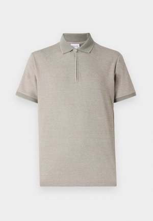 Light beige polo shirt with short sleeves, a zippered collar, and contrasting green accents on the collar and sleeve hems. Soft texture.